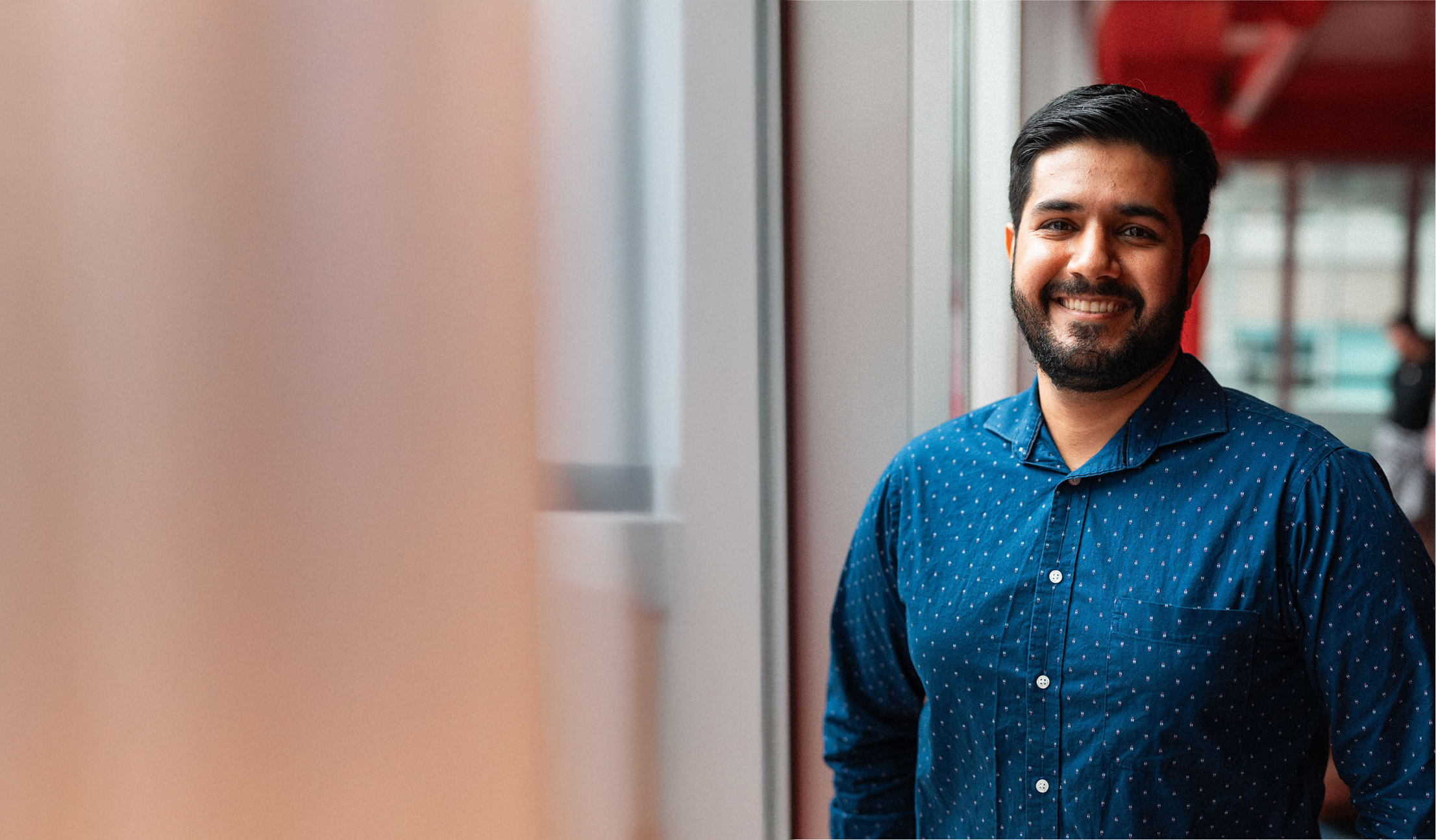 An Adler University student smiles in the library of the Vancouver Campus.