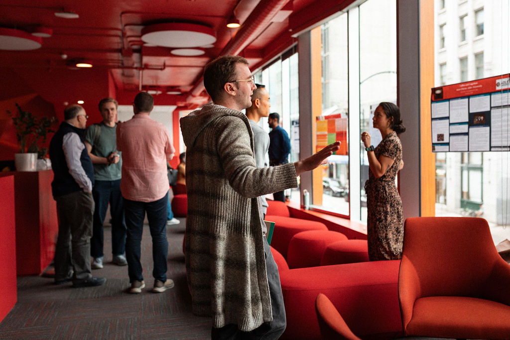 Students present their research projects in the common area at the Vancouver campus of Adler University.