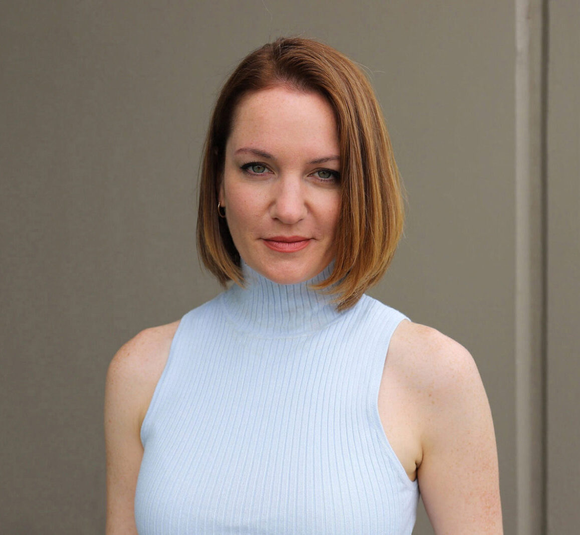 Woman wearning a light blue turtleneck with chin-length hair