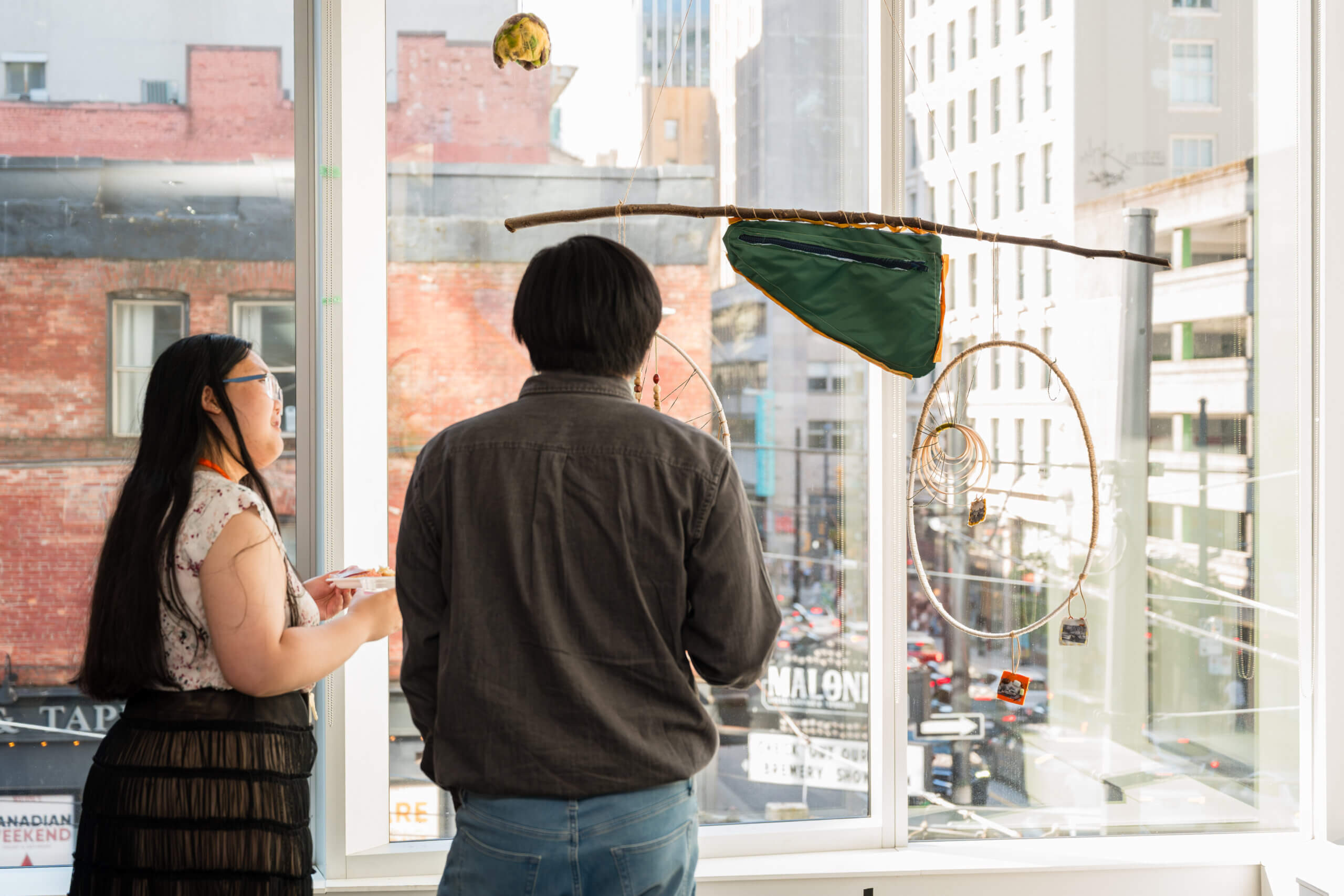 Students discuss an art piece at Adler University's Vancouver Campus.